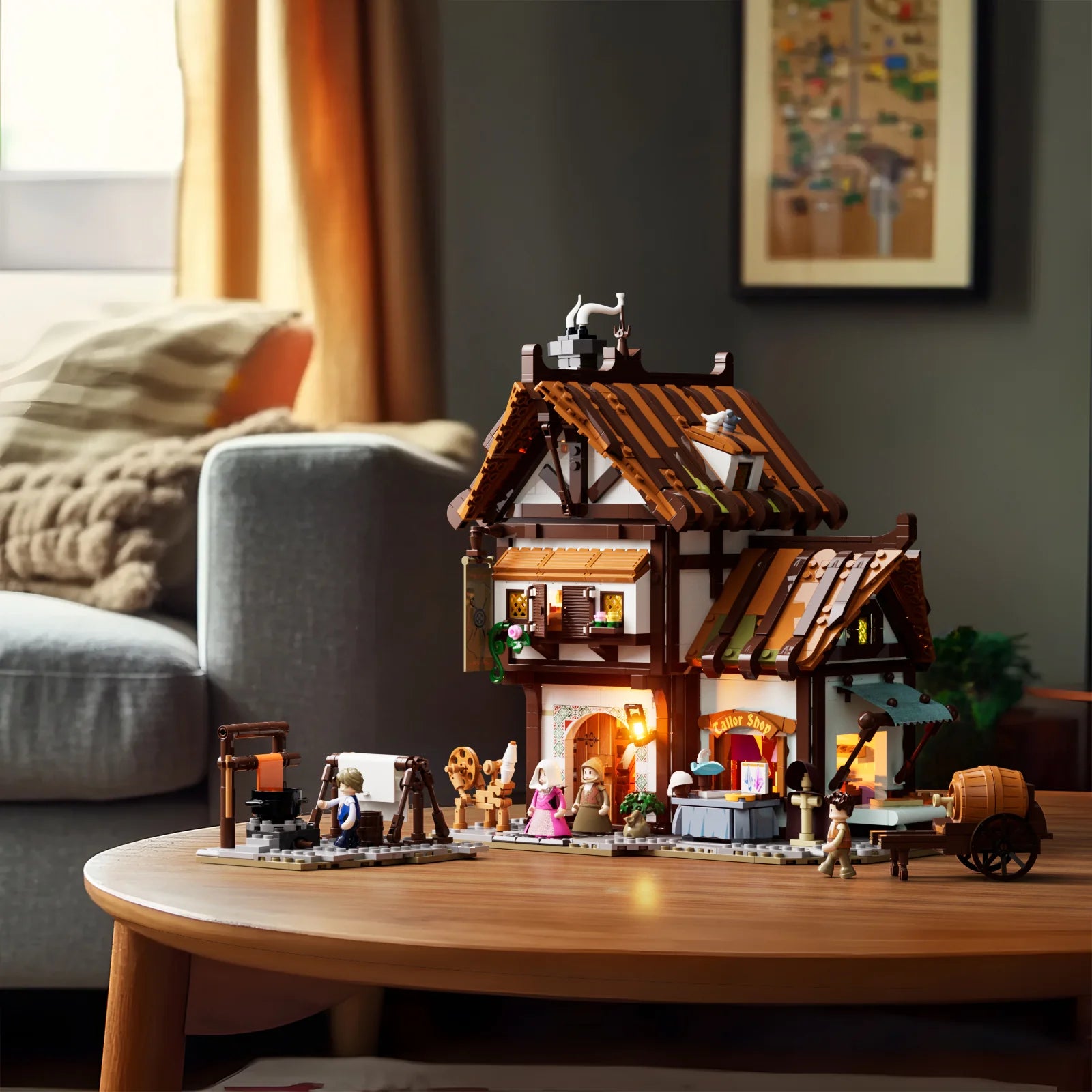 Lumibricks F9038 Medieval Tailor Shop on living room table with illuminated windows, roof details, and minifigures