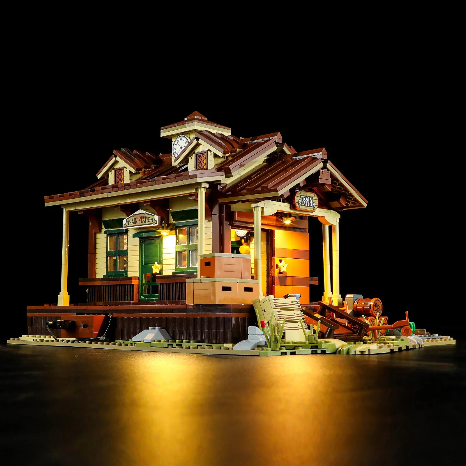Lumibricks (formerly Funwhole) F9039 Western Train Station side angle with crates, wagon, and warm interior lighting.