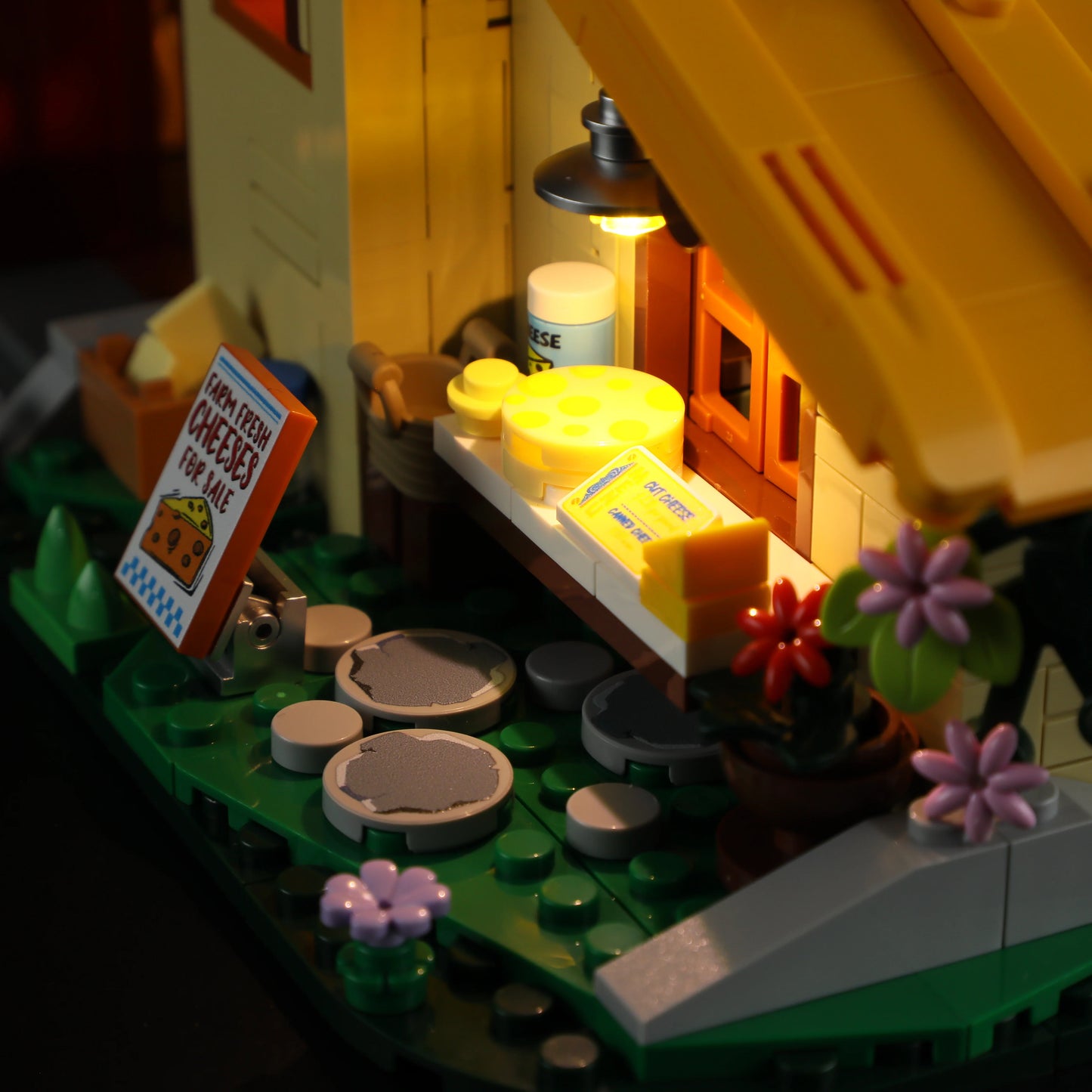 Lumibricks (Formerly Funwhole) F9049 Farm Cheese House cheese stand with wheels, butter, flowers, and illuminated porch