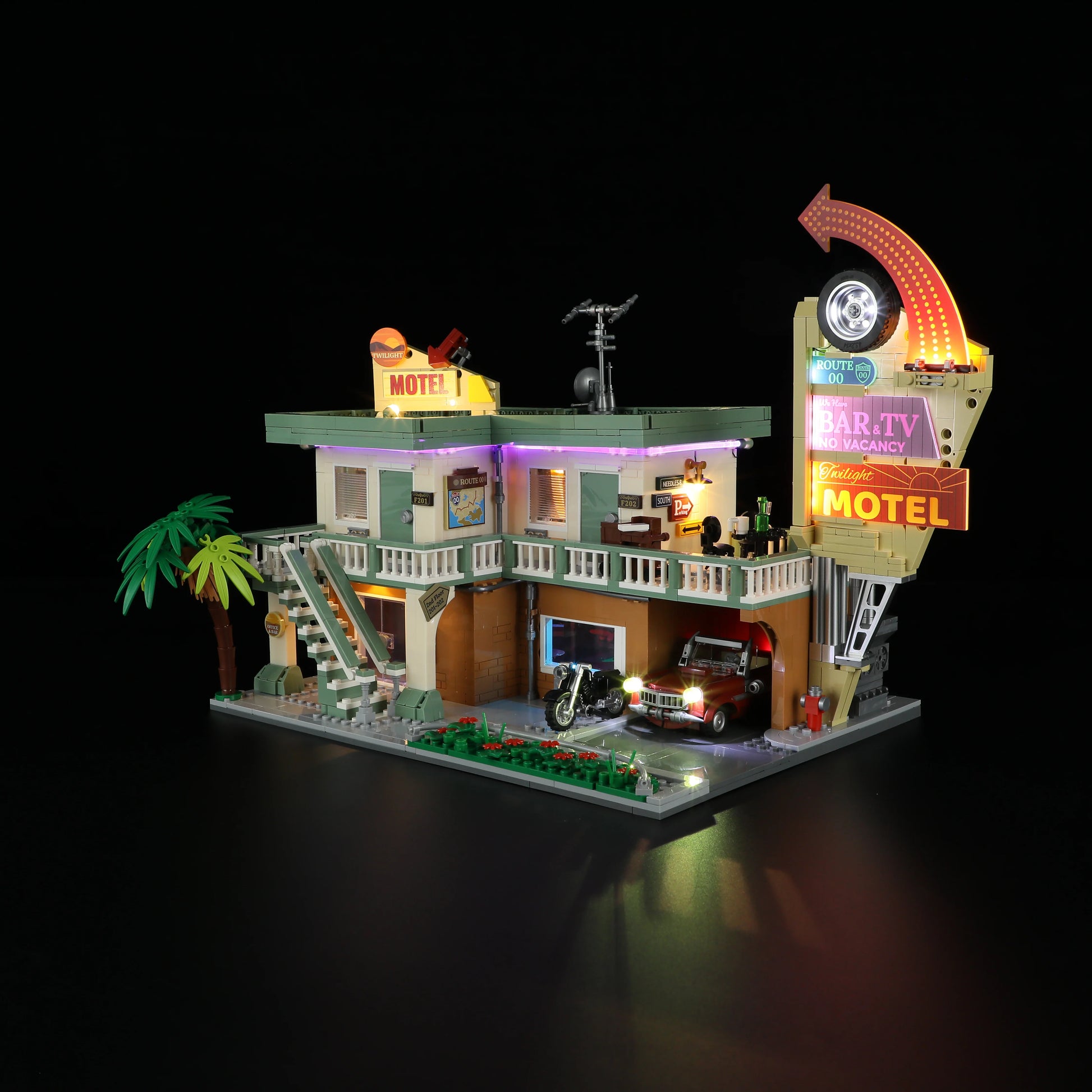 Lumibricks (Formerly Funwhole) F9054 Twilight Motel at night, angled view with LED lights, neon sign, minifigures, and classic car