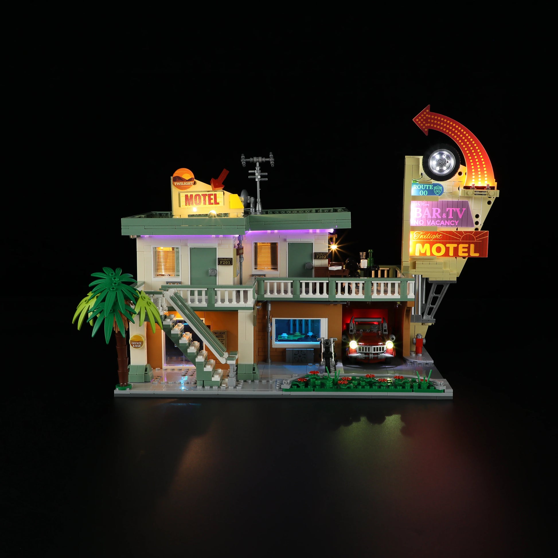 Lumibricks (Formerly Funwhole) F9054 Twilight Motel front view at night with glowing LED lights, neon sign, and detailed exterior