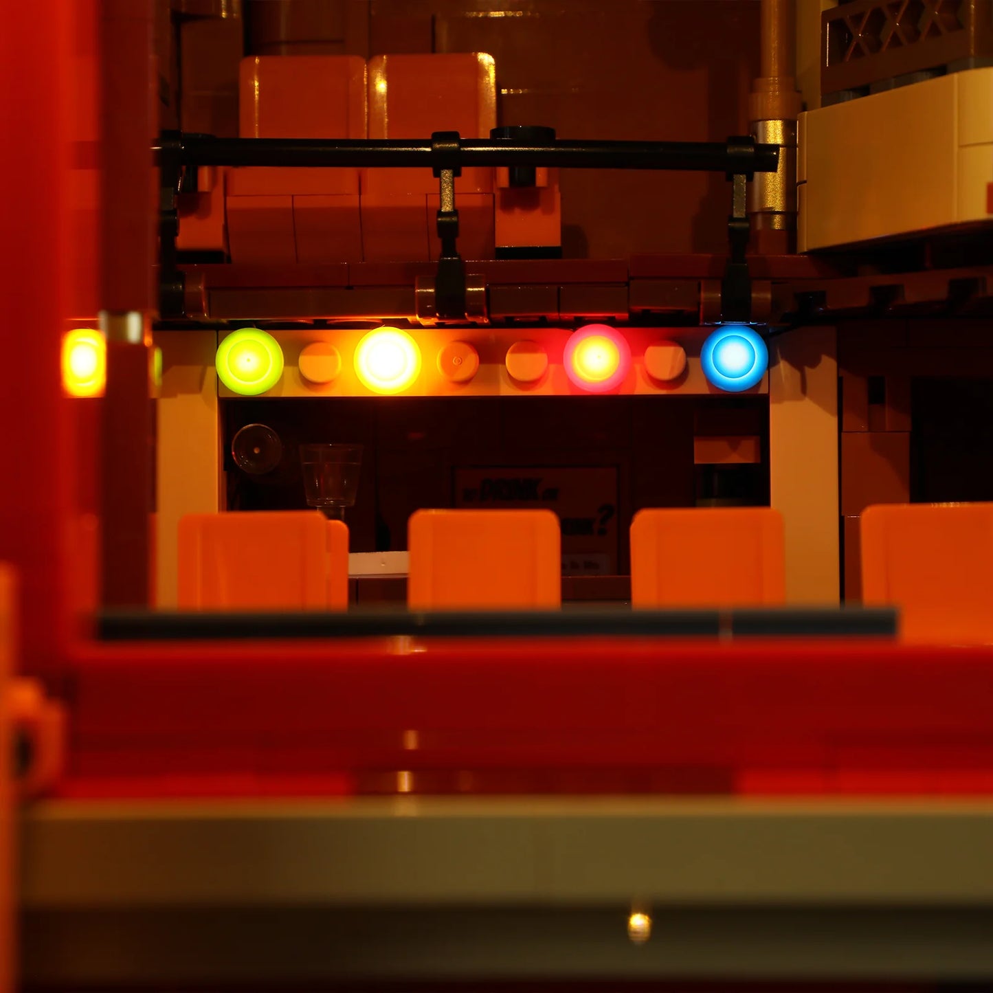Lumibricks (Formerly Funwhole) F9056 Balcony Theatre stage view with colorful LED spotlights and orange tiered seating