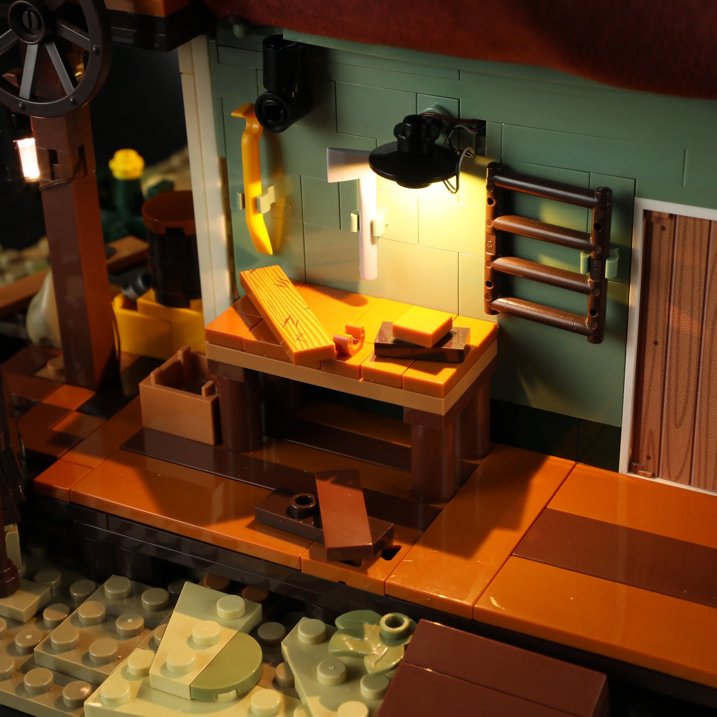 Lumibricks (Formerly Funwhole) F9057 General Store close-up of illuminated workbench with tools, lumber, and rustic details