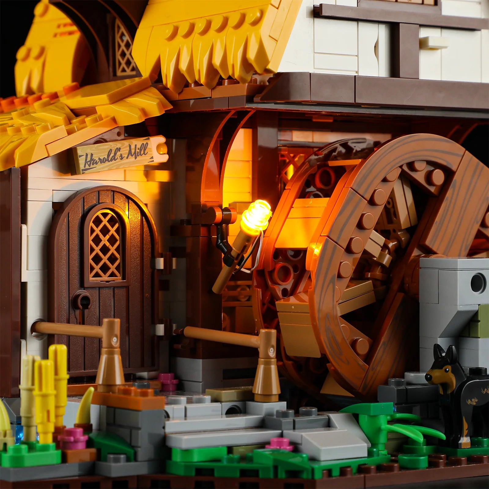 Lumibricks (Formerly Funwhole) F9061 Medieval Water Mill close-up of illuminated entrance, waterwheel, and Harold’s Mill sign