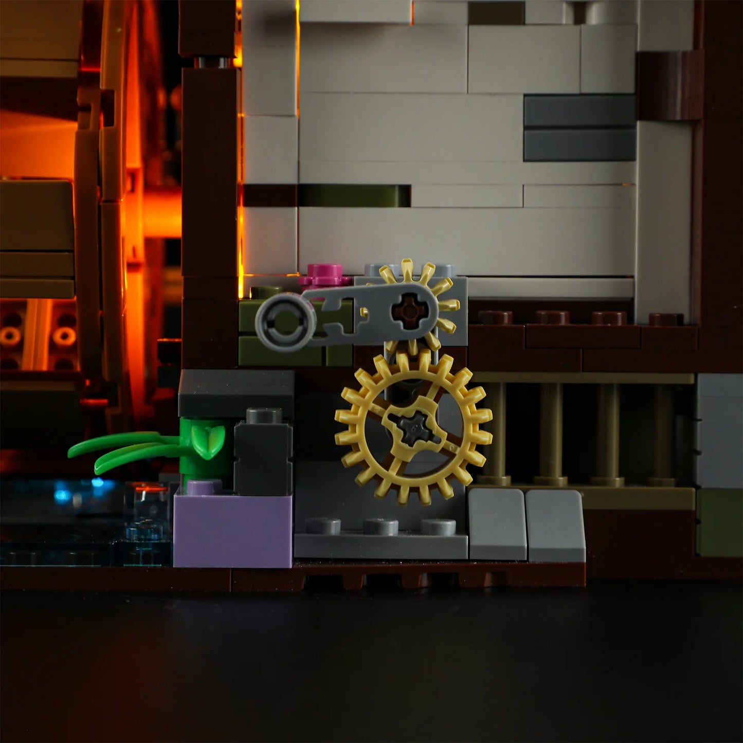 Lumibricks (Formerly Funwhole) F9061 Medieval Water Mill close-up of exterior gears, illuminated window, and waterwheel mechanism