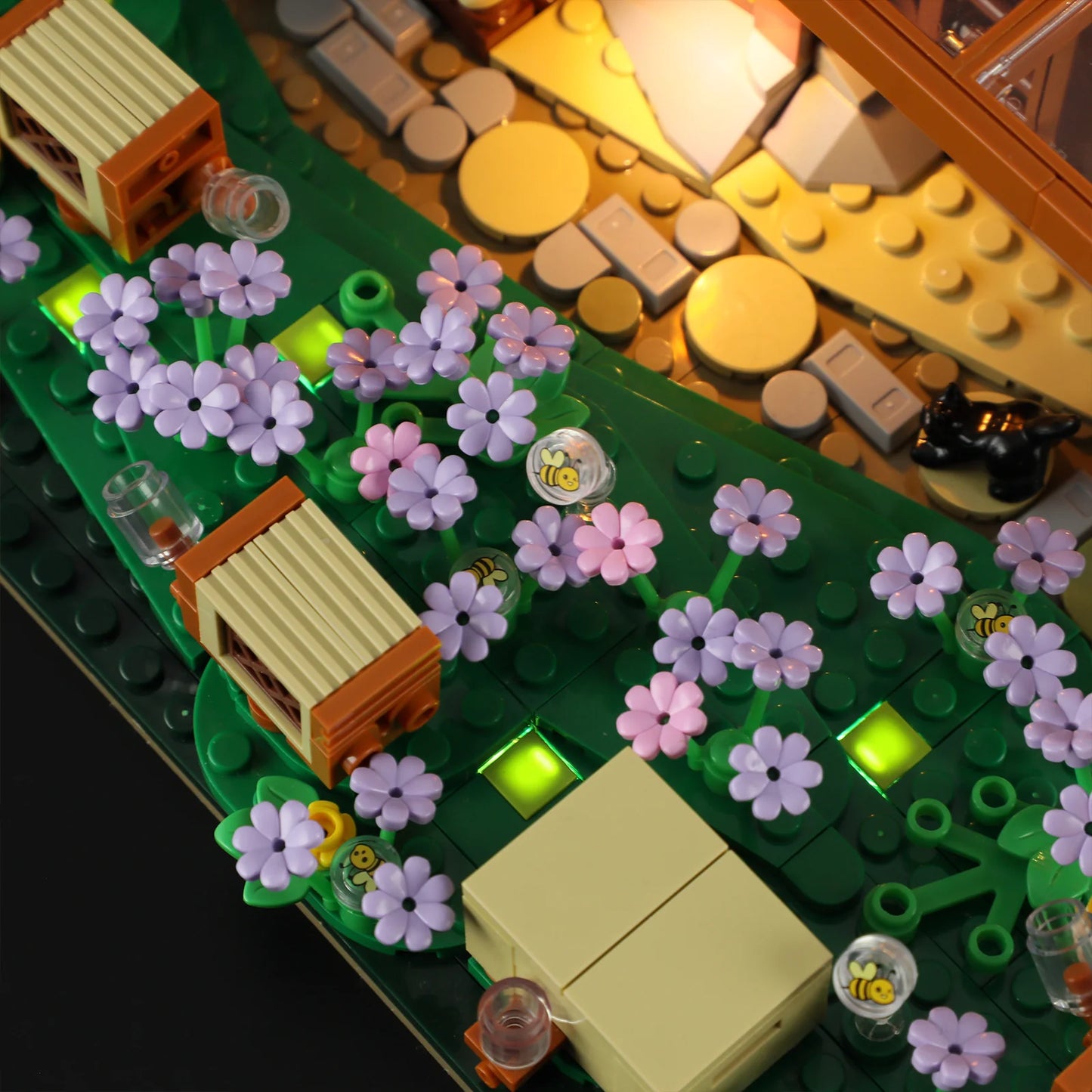 Lumibricks (Formerly Funwhole) F9062 Bee Farm close-up of illuminated flower garden, beehives, and bee-printed clear domes