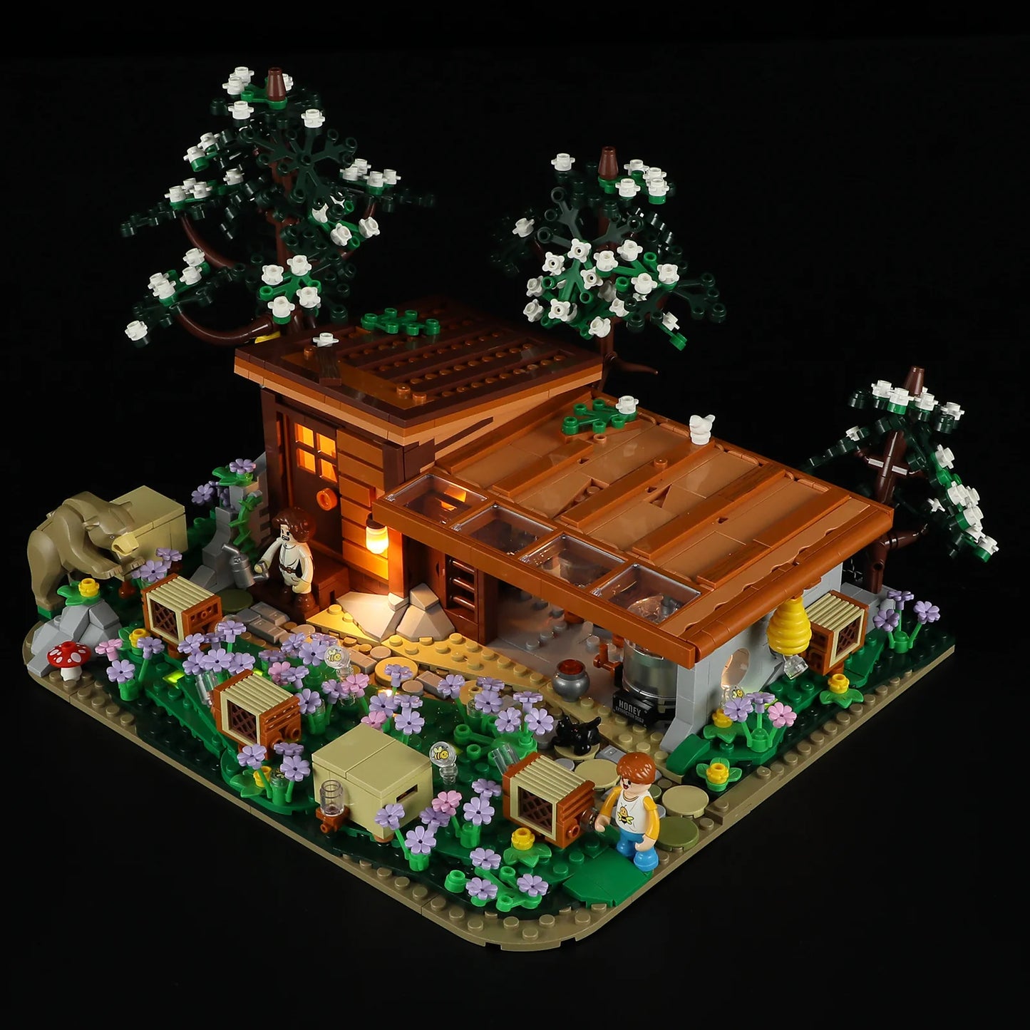 Lumibricks (Formerly Funwhole) F9062 Bee Farm at night with LED lights, illuminated windows, minifigures, and beehives