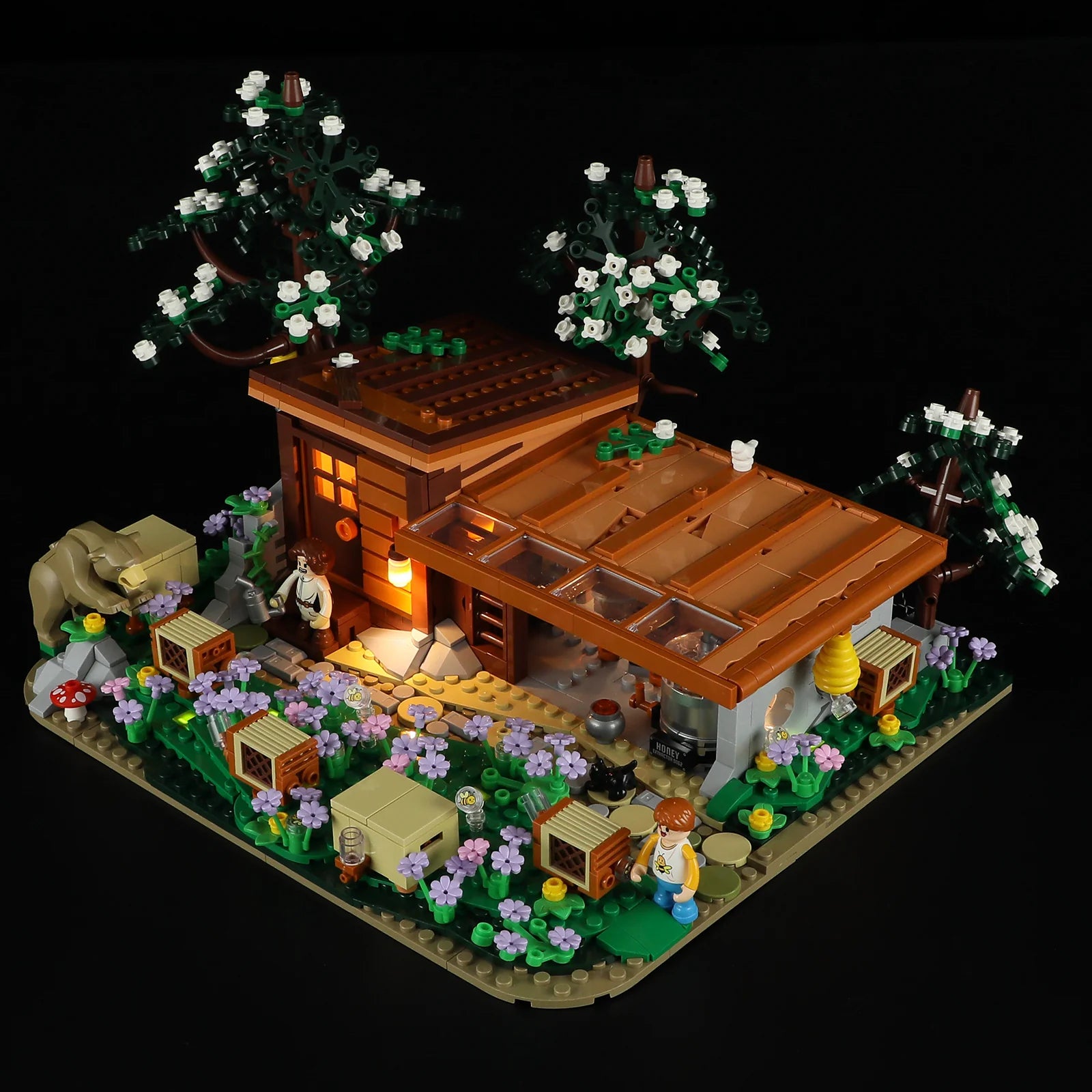 Lumibricks (Formerly Funwhole) F9062 Bee Farm at night with LED lights, illuminated windows, minifigures, and beehives