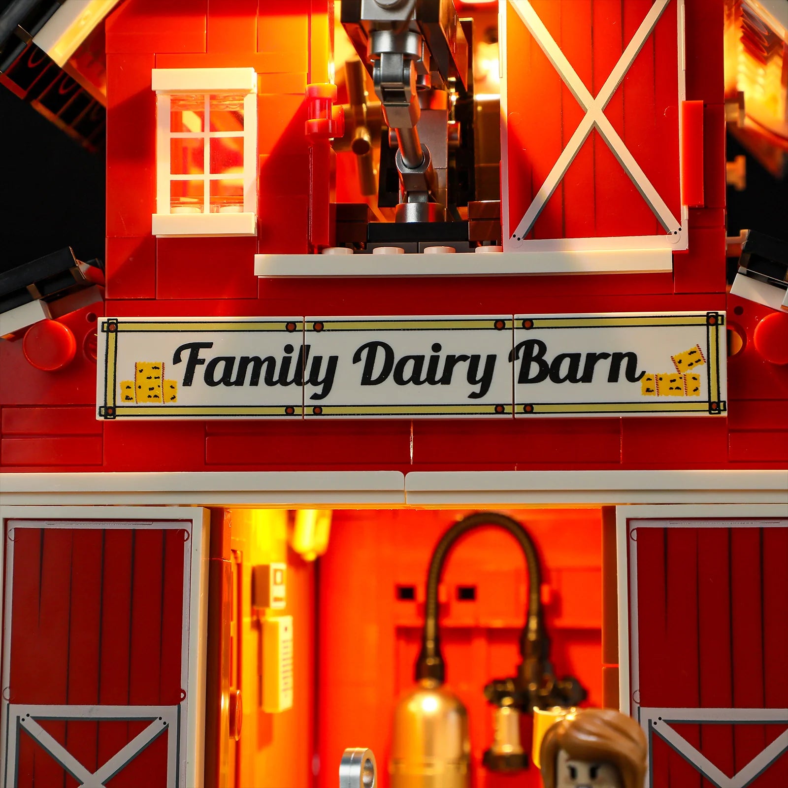 Lumibricks F9037 Cow Barn front entrance with "Family Dairy Barn" sign, open double doors, and illuminated milking equipment
